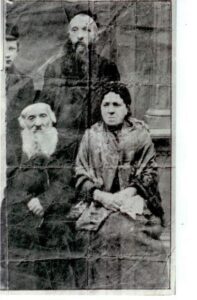Sitting: Rav Yechiel Issamar and Leah Wolgelernter; Standing: right-son Rav Yeshayah and on left partially visible  his son  Avraham